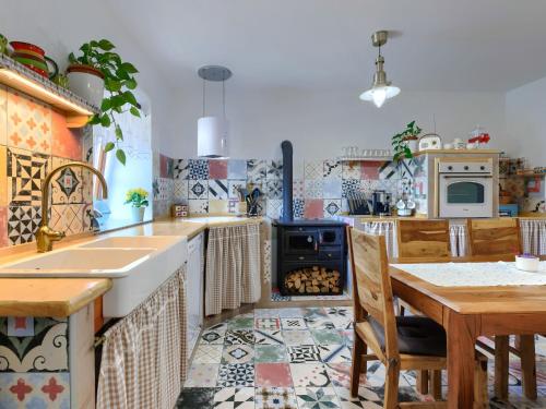 a kitchen with a table and a stove top oven at Holiday Home Villa Nicolara by Interhome in Buzet