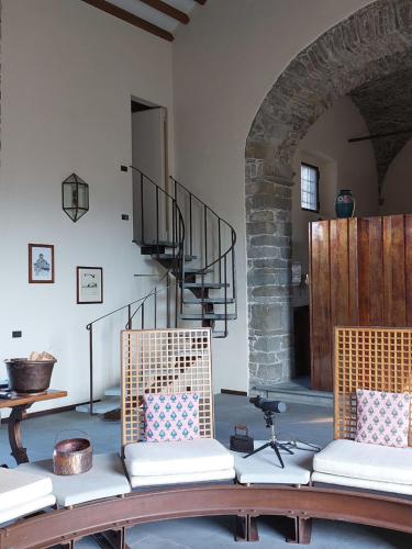 a living room with two chairs and a staircase at Holiday Home Villa La Chiesa by Interhome in Bosco