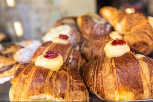 a bunch of croissants and other pastries on display at Apartment NAPOLI MARADONA in Naples