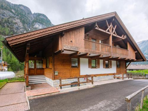 a large wooden house with a balcony on top at Chalet Cesa Galaldriel-3 by Interhome in Penia