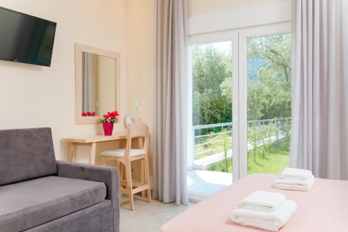 a living room with a couch and a table and a window at Aenaon studios in Limenas