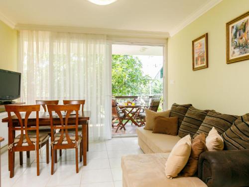 a living room with a couch and a table at Apartment Figo by Interhome in Balatonőszöd