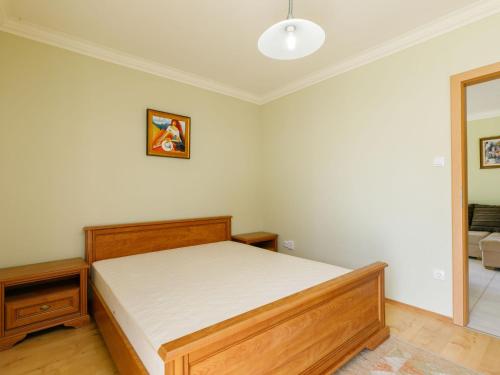 a bedroom with a wooden bed in a room at Apartment Figo by Interhome in Balatonőszöd