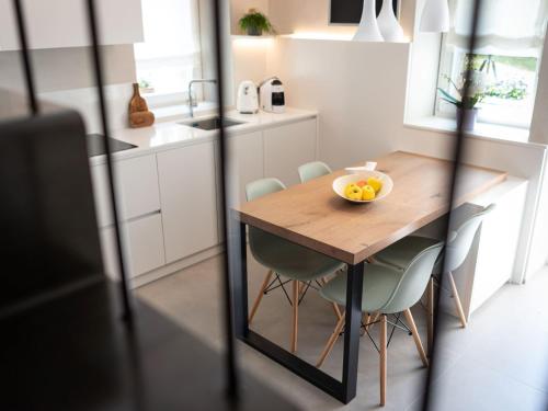 a kitchen with a wooden table with a bowl of fruit on it at Holiday Home Casa Maria by Interhome in Spert