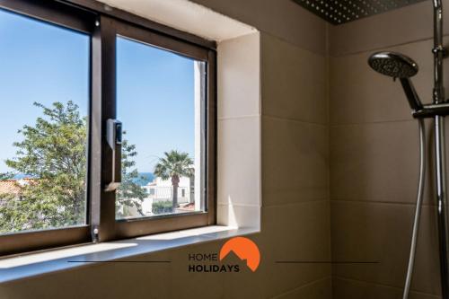 a shower in a bathroom with a window at #072 Casa Longa by Home Holidays in Albufeira