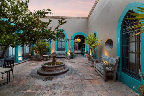 a courtyard with a fountain in the middle of a building at Casa Antigua by Domi Housing in Querétaro
