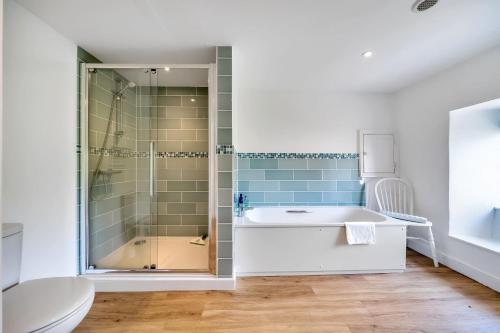 a bathroom with a shower and a sink and a toilet at Lower Farm Cottage 