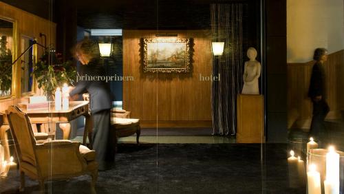 a man sitting at a table in a room with candles at Primero Primera in Barcelona