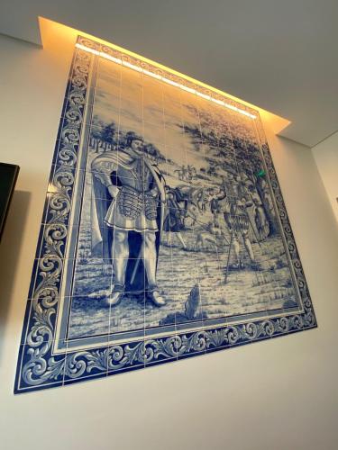 a tapestry hanging on a wall in a room at Villa Rey Spa & Hotel in Vila de Rei