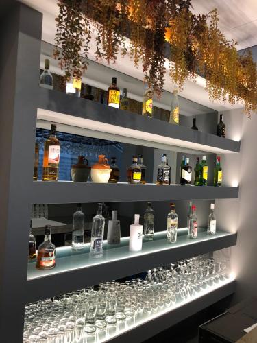 a shelf filled with lots of wine glasses at Villa Rey Spa & Hotel in Vila de Rei