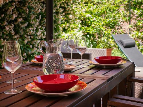 a wooden table with plates and wine glasses on it at Ca' Mazzega in Murano