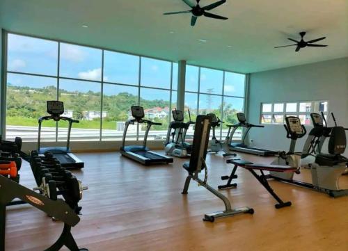 a gym with several treadmills and elliptical machines at Valley Suites by WyattHomes in Kuantan