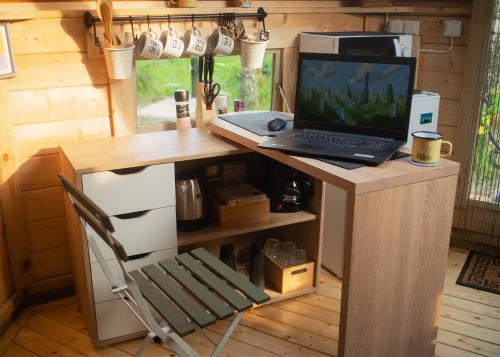 a laptop computer sitting on a desk in a room at Troll House Eco-Cottage, Nuuksio for Nature lovers, Petfriendly in Espoo
