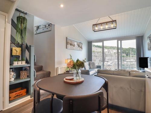 a living room with a table and a couch at Moelwyn 57D South Snowdon Wharf in Porthmadog