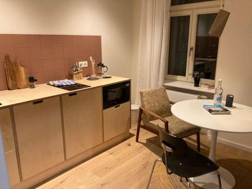 a kitchen with a table and a table and chairs at Arbio I Lax Apartments in Leipzig