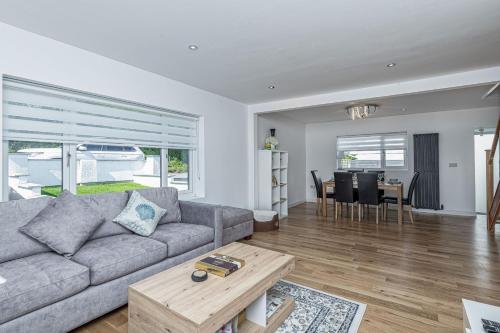 a living room with a couch and a table at Clydfan in Holyhead
