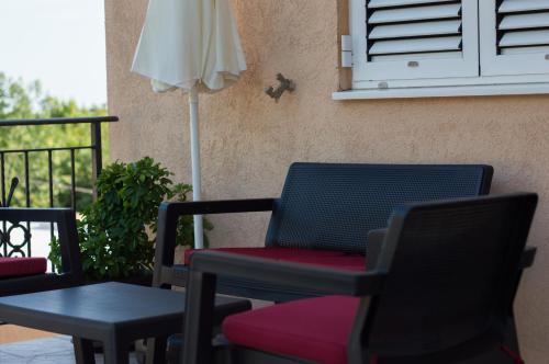 a patio with chairs and a table and a window at Villa Pari Apartment in Kotor
