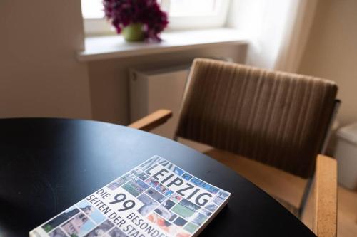 a newspaper sitting on top of a table at Arbio I Lax Apartments in Leipzig