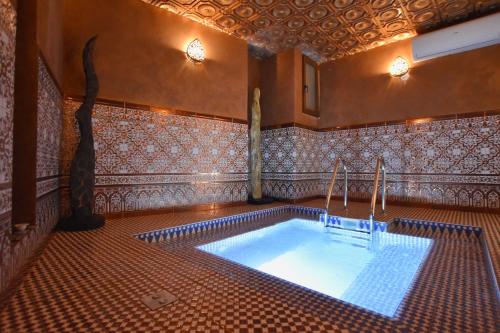 a hot tub in a room with a tiled floor at Chapel 5 Boutique Suites B&B in Naxxar
