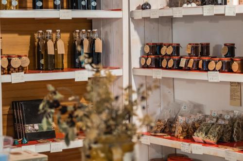 a store with shelves filled with bottles of wine at Ostello dei Giardini di Pomona in Cisternino