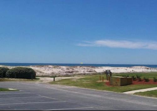 an empty road with the ocean in the background at Gulf Shores Plantation Condos in Gulf Shores