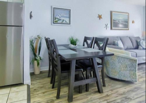 a dining table and chairs in a kitchen with a couch at Gulf Shores Plantation Condos in Gulf Shores