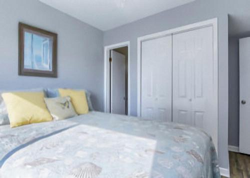 a bedroom with a large bed with yellow pillows at Gulf Shores Plantation Condos in Gulf Shores