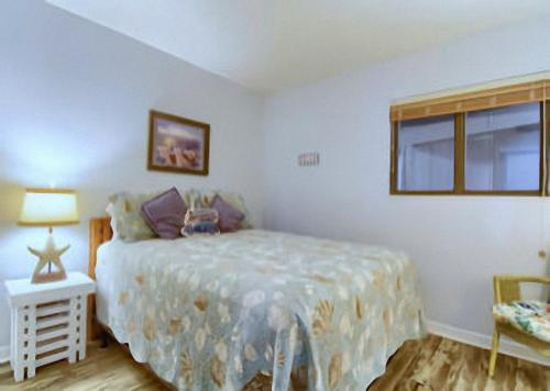 a bedroom with a bed and a window at Gulf Shores Plantation Condos in Gulf Shores