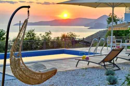 a swinging hammock next to a pool with the sunset at Seaview Villa Lavanda with pool in Budva