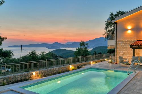 a swimming pool with a view of the mountains at Seaview Villa Lavanda with pool in Budva