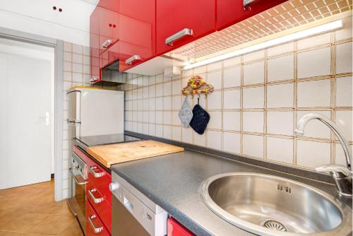 a small kitchen with a sink and red cabinets at Oceane Paradise- Charlot in Levanto