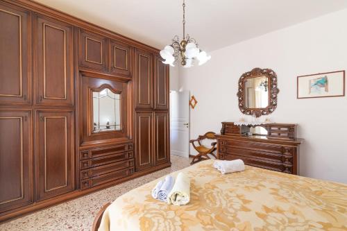 a bedroom with a bed and a dresser and a mirror at Angolo di cielo in Castellammare del Golfo
