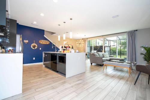 a kitchen and living room with blue walls at Enchanting Four Bedrooms Townhouse at Le Reve Resort (211021) in Kissimmee
