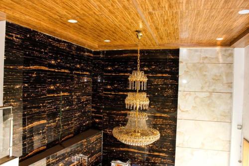a chandelier hanging from the ceiling in a room at TRI HOTEL in Mumbai