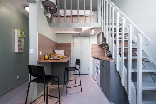 a kitchen with a staircase and a kitchen with stools at My CASA - SAINT SIAGRE 3 in Nice