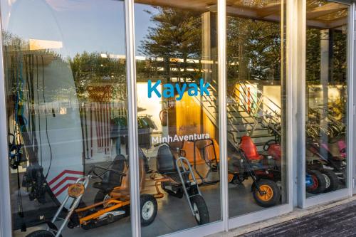 a window of a store with scooters in it at Casa do Faria in Caminha