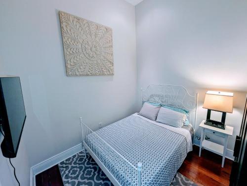 a small bedroom with a bed and a picture on the wall at Royal Residence in New Orleans