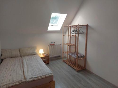 a bedroom with a bed and a book shelf at Jagodzianka in Miłki