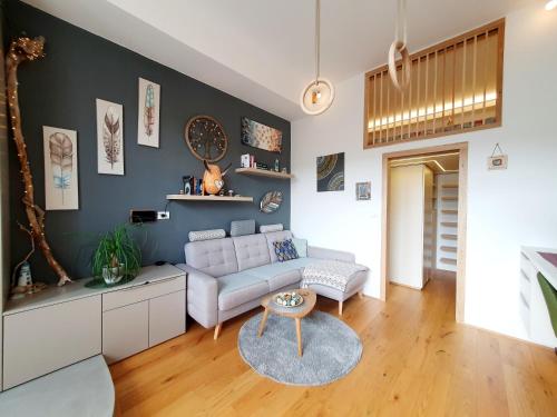 a living room with a couch and a table at Harmony - Your Cozy Retreat a Short Walk from the Center in Portorož