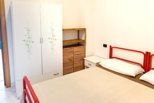 a small bedroom with two beds and a closet at SE008 - Senigallia, bilocale sul mare con spiaggia in Senigallia