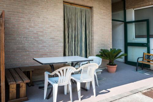 a table and chairs sitting on a patio at SE008 - Senigallia, bilocale sul mare con spiaggia in Senigallia