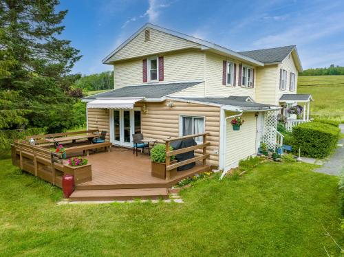 a large wooden deck with a house at Mountain Treasure Bed and Breakfast in Maplecrest