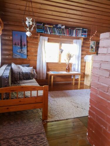 a living room with a couch and a table at Kallioranta in Lestijärvi