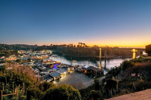 a marina with boats in the water at sunset at Harbor Lite Lodge in Fort Bragg