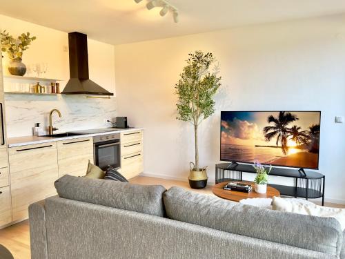 a living room with a couch and a table at FLAIR Apartments Vorarlberg - Stilvolles Wohnen nahe Bodensee & Alpen - Küche, Balkon & Gratis Parkplatz in Bregenz