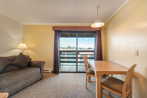 a living room with a couch and a table at Harbor Lite Lodge in Fort Bragg