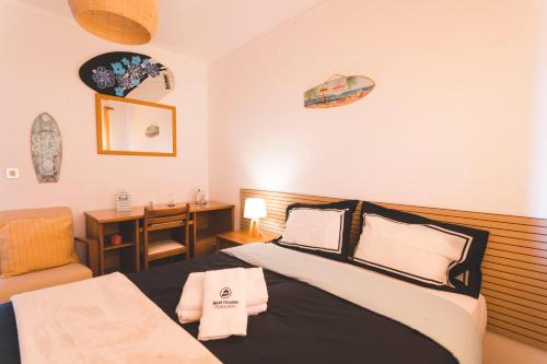 1 dormitorio con 1 cama y escritorio con silla en Best Houses 49 - Tiago´s Surf Beach House, en Atouguia da Baleia