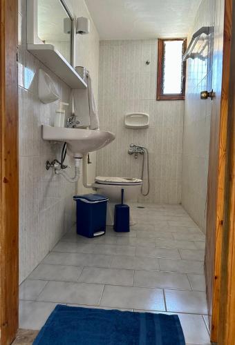 a bathroom with a sink and a toilet at BONATSA ROOMS in Palaiochóra