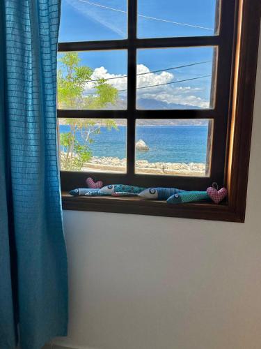 a window with a view of the beach at BONATSA ROOMS in Palaiochóra