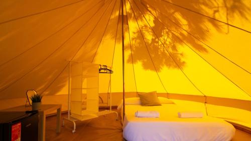 a bedroom with a bed in a tent at Glamping Atlántico in Ferrol